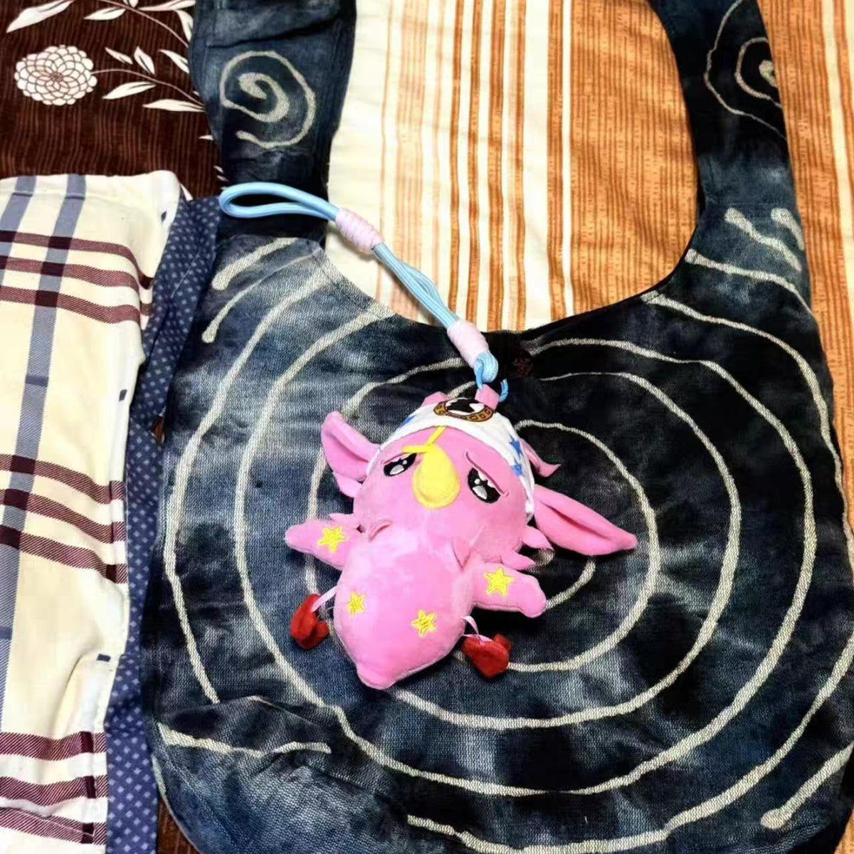 Pink Star Plush Keychain - hanging on a dark tote
