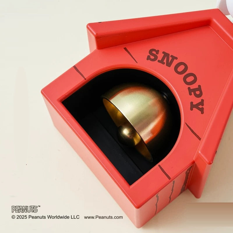 Close-up of the brass bell inside the doghouse