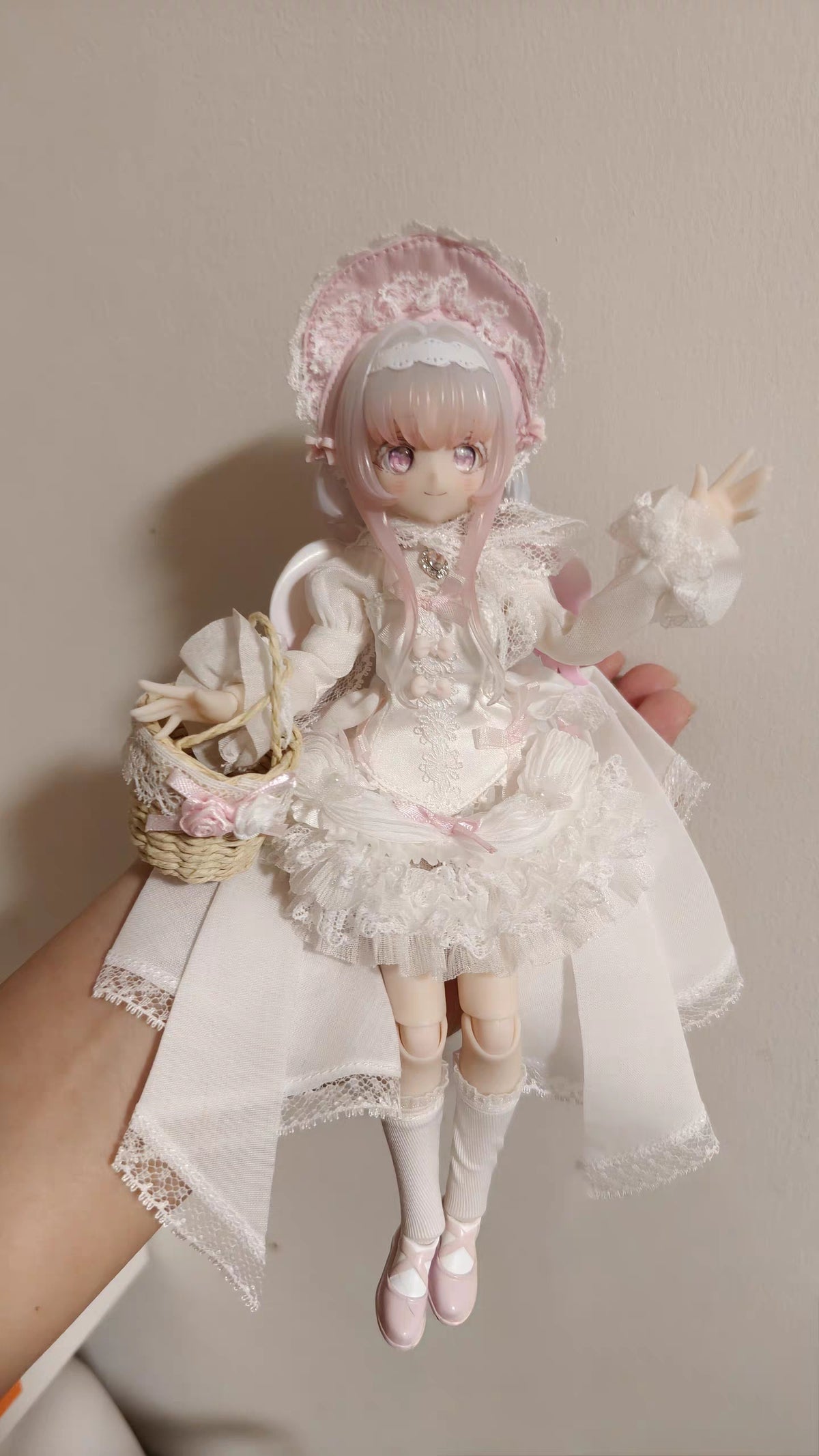 Melliel BJD held in hand showing joint articulation