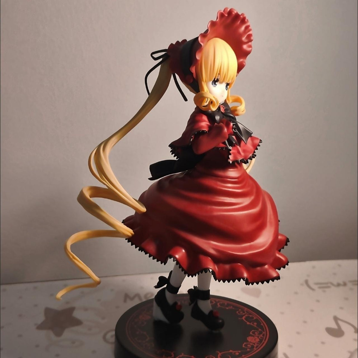 Shinku figure three-quarter side view, red bonnet and twin-tail hair